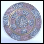 A 19th century Indian brass charger of circular form having silver and copper overlay decoration