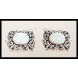 A pair of sterling silver cufflinks having large central opal panels. Weighs 10.1 grams.