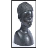 An early 20th Century African hardwood ebony carved bust, the bust carved in great detail of a young
