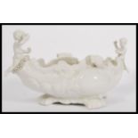 A 20th century Blanc De Chine Parian ware Italian centerpiece of scrolled form having cherub