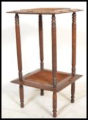 A vintage early 20th Century Arts and Crafts style carved oak two tiered pot stand / lamp table, the