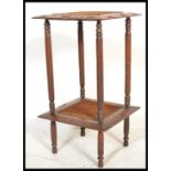 A vintage early 20th Century Arts and Crafts style carved oak two tiered pot stand / lamp table, the