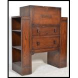A 1930's Art Deco oak bureau. The central fall front bureau with appointed interior set over a