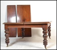 A large 19th century Victorian mahogany extending twin leaf dining table. The large, wide table