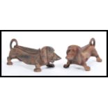 A pair of 20th century cast metal boot scrapers / door stops in the form of Dachshund dogs with