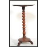 A 19th century mahogany wine table / barley twist plant stand. Raised over a terraced base with