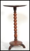A 19th century mahogany wine table / barley twist plant stand. Raised over a terraced base with