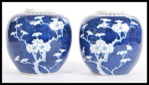 A pair of 19th century Chinese blue and white Prunus pattern ginger jars of ovoid form having blue