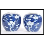 A pair of 19th century Chinese blue and white Prunus pattern ginger jars of ovoid form having blue