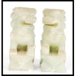 A pair of vintage 20th Century Chinese carved green stone fu dogs, the dogs in seated position