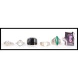 A selection of 925 silver rings to include a ring set with a large rectangular purple stone, a