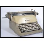 A vintage mid 20th Century retro industrial typewriter by Adler stamped for West Germany. Along with
