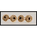 A pair of hallmarked 9ct gold gents cufflinks ( cufflink cuffs ) of rope twist knot form. Weighs