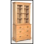 A Victorian 19th century country pine bookcase on chest of drawers. Raised on bun feet with short