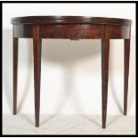 A 19th century George III mahogany demi lune tea table / games card table. Raised on square tapering