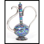 A 20th Century silver ornamental Cloisonne teapot raised on a round foot with a bulbous body and