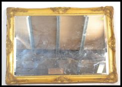 A good quality antique regency revival gilt overmantel wall mirror. The large mirror glass inset