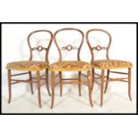A set of 3 Victorian mahogany faux bamboo aesthetic movement balloon back dining room chairs with