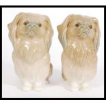 A pair of LLadro ceramic figurines of Pekingese dogs 4641, the dogs modelled in the sitting
