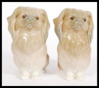 A pair of LLadro ceramic figurines of Pekingese dogs 4641, the dogs modelled in the sitting