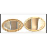 Two 19th century Victorian gilt wood oval wall mirrors. Each oval cushion frame with shaped design