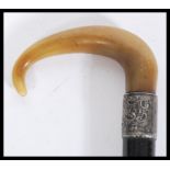 A 19th century silver hallmarked collared walking stick cane having a tapering ebony shaft with