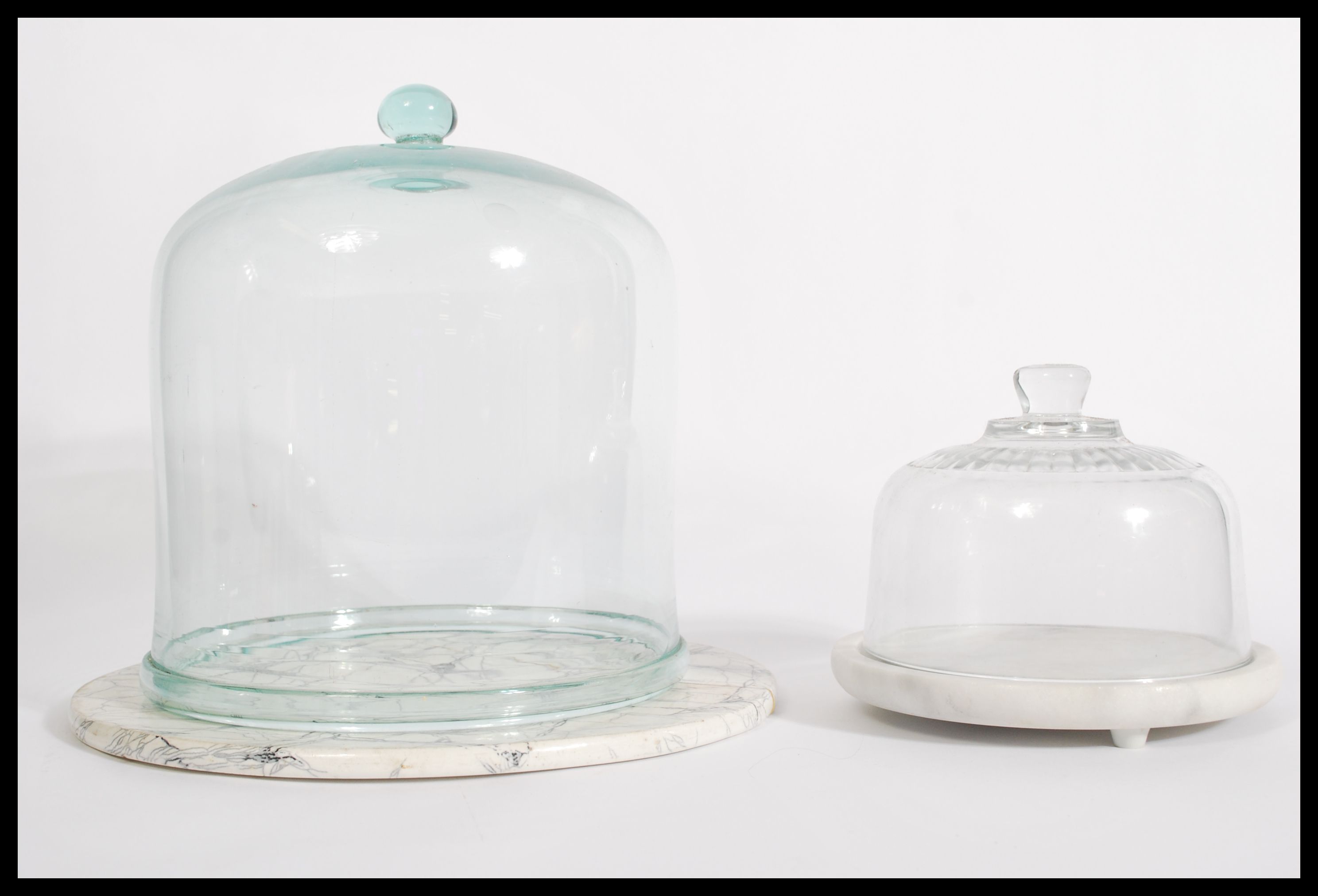 A collection of 2 vintage 20th century glass cloche's of varying sizes, each of bell form with