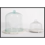 A collection of 2 vintage 20th century glass cloche's of varying sizes, each of bell form with