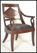A 20th century mahogany desk chair of Regency revival style with swan neck elbow supports,