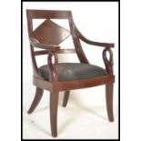 A 20th century mahogany desk chair of Regency revival style with swan neck elbow supports,