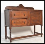 An early 20th Century Edwardian oak sideboard with galleried back and two drawers next to single