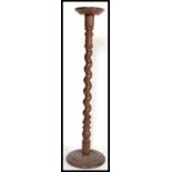 A good Victorian 19th century mahogany torchere plant stand of tall form raised a barley twist
