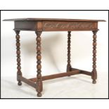 An 18th century Jacobean revival carved oak lowboy writing table desk being raised on block and