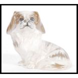 A Royal Copenhagen ceramic dog figurine of sitting Pekingese model number 1772. Painted and