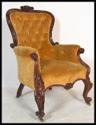 A 19th century Victorian mahogany armchair of rococo form having a stunning show wood frame raised