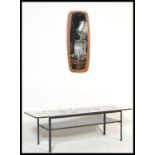 A vintage retro 20th century low coffee table raised on a metal frame with retro print top