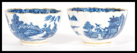A pair of early 19th Century English porcelain tea bowls having blue and white decoration with