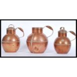 A set of 3 early 20th century Guernsey copper lidded milk jugs of graduating form with shaped