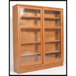 A mid 20th century solid golden oak upright lawyers bookcase cabinet having multiple shelves with