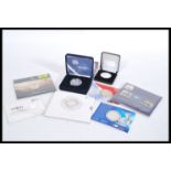 A collection of silver proof commemorative coins to include a Royal Navy £5 Commemorative Coin (