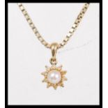 A hallmarked 9ct gold pendant necklace on a box chain having a hallmarked 9ct gold pendant set