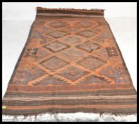 An early 20th century Turkish  Kilim carpet rug  having red, blue and black ground in a decorative