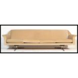 A Danish 1960's vintage retro sofa settee upholstered in cream velour raised on metal splayed