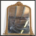 A 19th Century Victorian gilt framed arched topped overmantel mirror, the crested top above the bead