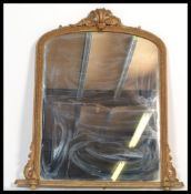 A 19th Century Victorian gilt framed arched topped overmantel mirror, the crested top above the bead
