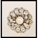 A 14ct white gold diamond and pearl cluster ring having a central pearl with two halos of