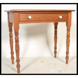 A 19th century Victorian pitch pine writing table desk being raised on turned legs with single