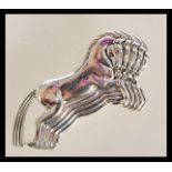 A sterling silver brooch in the form of four leaping horses. Stamped sterling. Weighs 9.2 grams.
