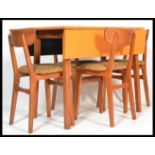 A stunning vintage 20th Century circa 1960's dining suite, consisting of a orange laminated topped