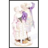 A 19th century Meissen porcelain figurine group of a gallant and companion raised on scrolled